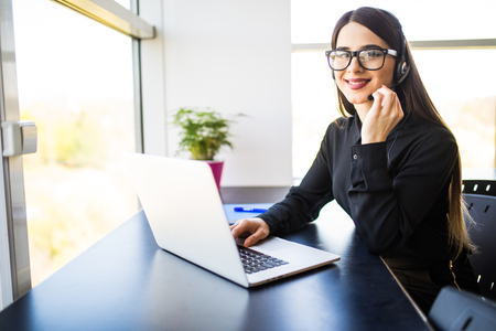 Female customer support operator with headset and smilingの写真素材