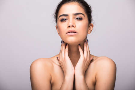 Beautiful face of a young woman with clean fresh skin isolated