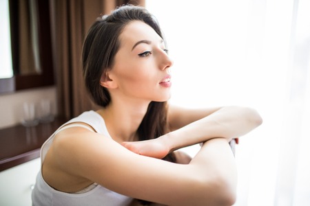 Relaxing woman sitting comfortable in sofa lounge chair smiling happy looking at camera.の写真素材
