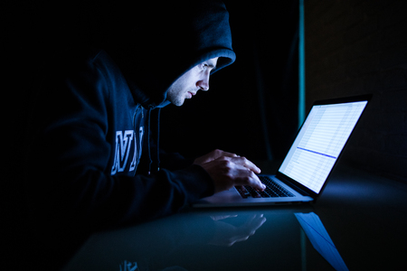 A man is a laptop dark room a man is working in a dark room