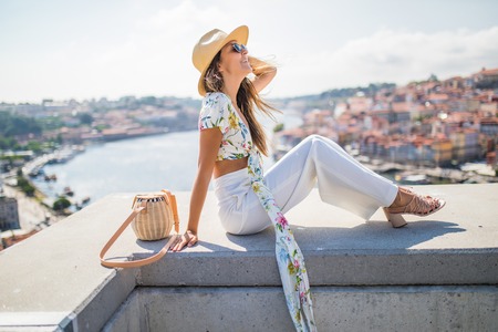 Young woman watching out over Porto rooftops