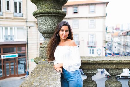 Portrait of happy smiling woman standing on the square on sunny summer or spring day outside,の写真素材