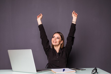 Young happy attractive woman at modern office desk, with laptop feeling great things on career horizon, saying yes to new adventures, cheerful good morning news, working toward success and reached itの写真素材
