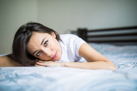 A woman lying on the bed and smiling