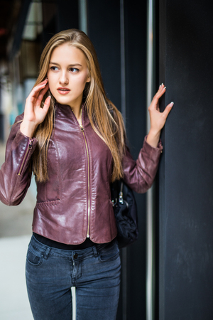Portrait of a beautiful woman smiling in urban backgroundの写真素材