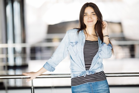 Beautiful business woman at the office leaning on the handrailの写真素材