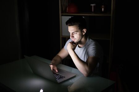 businessman working with computer at night at home
