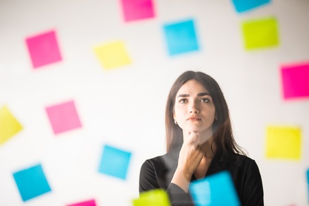 The sun shines in the window. Glues stickers and thinking over the projectの写真素材