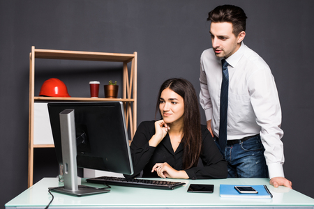 Business people discussing ideas at meeting using laptop in the officeの写真素材