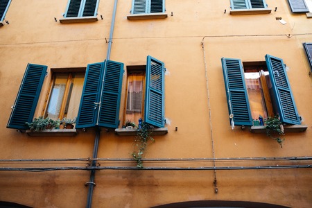 Colourful faceade and wooden window shutters, Bologna