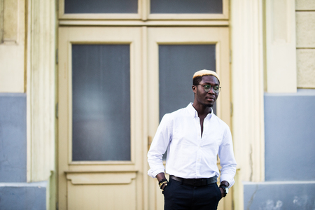 Portrait of a young man walking in the city streetの写真素材