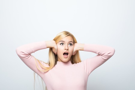 picture of woman with hands on ears.の写真素材