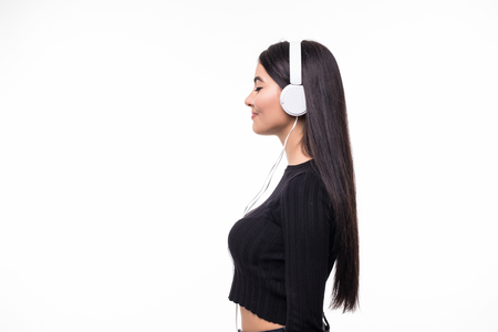 Portrait of beautiful woman student listening to music on white backgroundの写真素材