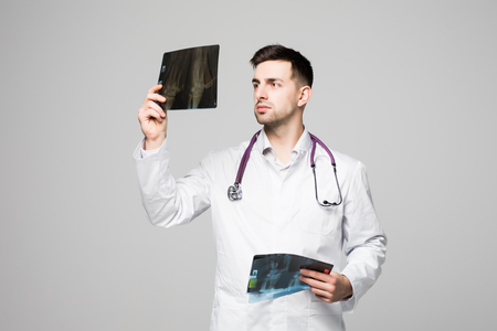 Doctor looking at x-ray on white backgroundの写真素材