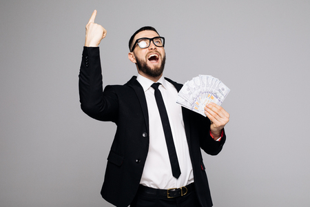 Image of screaming man in official suit standing isolated over grey wall background.の写真素材