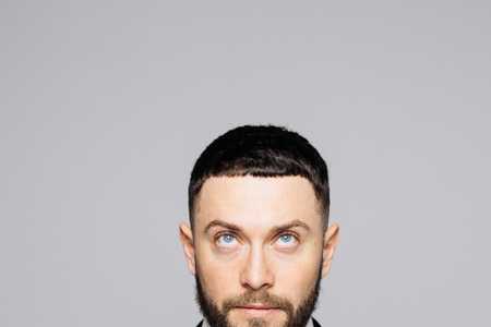 Cropped close up portrait of a charming man in a business suit, isolated on a white background