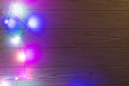 Blur christmas lights on wooden planks, depth of focus with copyspaceの写真素材
