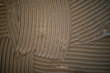 tile adhesive on a wall. Laying Ceramic Tiles.