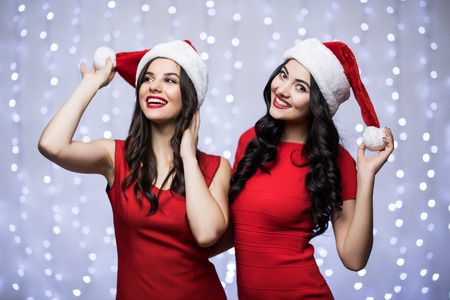 Portrait of funny couple with smartphones. Man and woman having fun together. Winter holiday Christmas and New Year conceptの写真素材