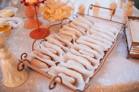 Colorful table with sweets and goodies for the wedding party reception, decorated dessert table. Delicious sweets on candy buffet.の写真素材