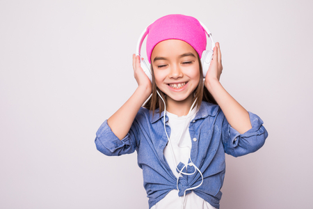Beautiful cute happy little girl with headphonesの写真素材