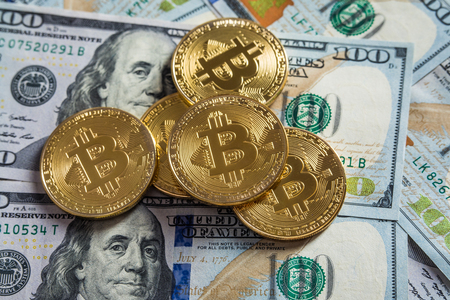 Golden bitcoin coins on a paper dollars money and dark background with sun. Virtual currency. Crypto currency. New virtual money Dollars money. Lens flareの写真素材