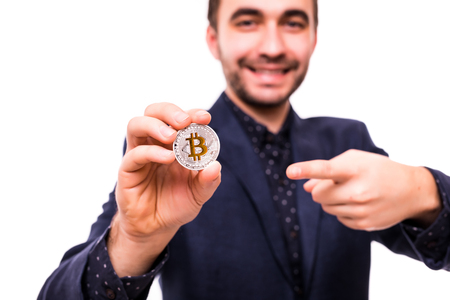 Young man pointed on bitcoin isolated on whiteの写真素材