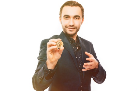 Young man pointed bitcoin on camera isolated on white backgroundの写真素材