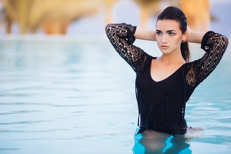 Portrait woman relax luxury pool infinity sea relax and swimの写真素材