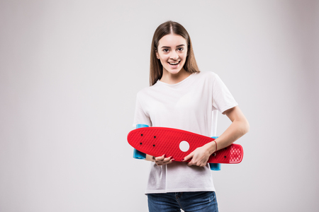 Funny girl with pink longboard isolated on grayの写真素材