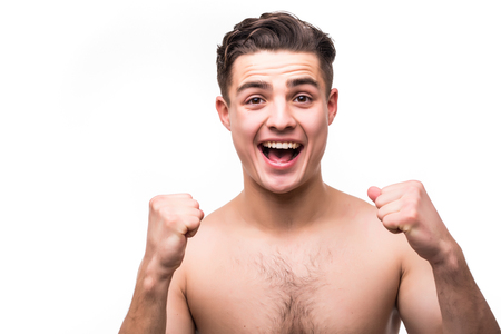 Studio portrait of handsome young man. Clean shaven man with naked torso looking at camera and screamingの写真素材
