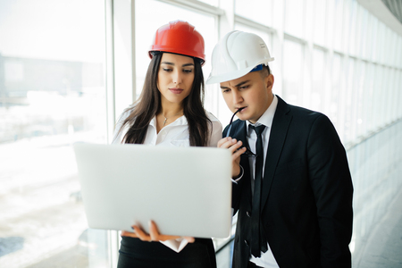 Group of engineer man and woman on construction site for check out the new project with laptop.の写真素材