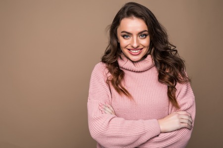 Beautiful young woman portrait isolated on brown backgroundの写真素材