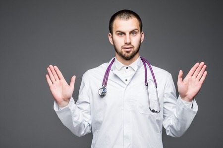 Studio shot of man doctor wearing eyeglasses against gray backgroundの写真素材