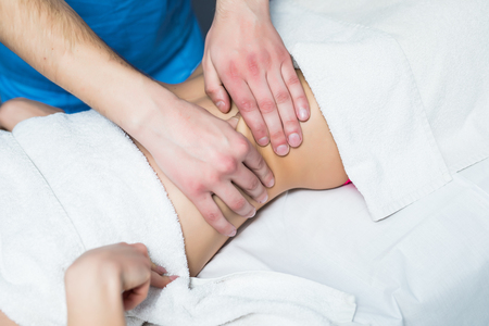 Masseur conducts anti-cellulite massage of the abdomenの写真素材