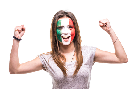 Pretty woman supporter fan of Mexico national team painted flag face get happy victory screaming into a camera.の写真素材