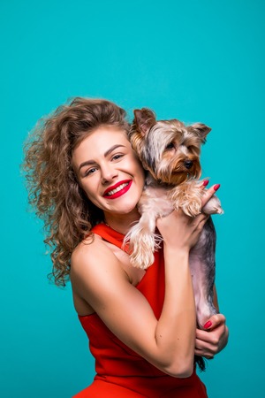 Closeup portrait of smiling young attractive woman embracing Yorkshire terrier. Yorkshire terrier concept isolated front view on white background.の写真素材