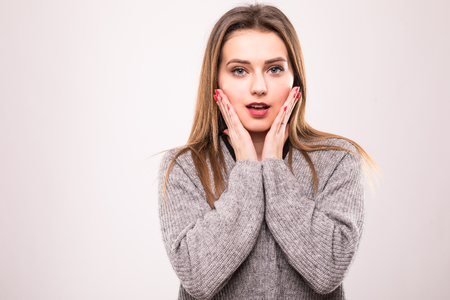 Portrait of shocked woman with mouth open looking away isolated on a gray backgroundの写真素材