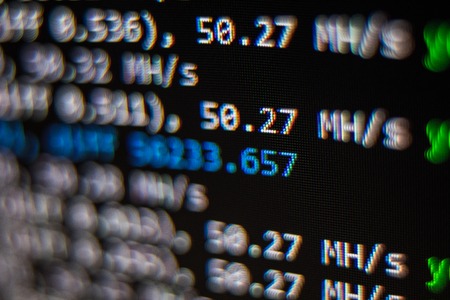 Macro snapshot of the program interface for crypto currency mining on the monitor of an office computer. The concept of mining bitcoins. The flow of information strings and dataの写真素材
