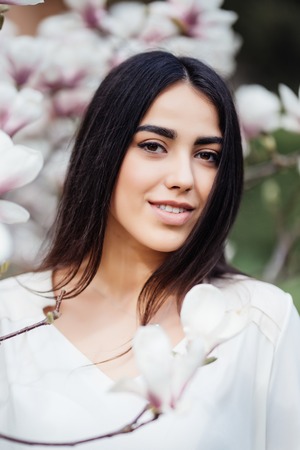 Face portrait of beauty woman neat blossom magnoliaの写真素材