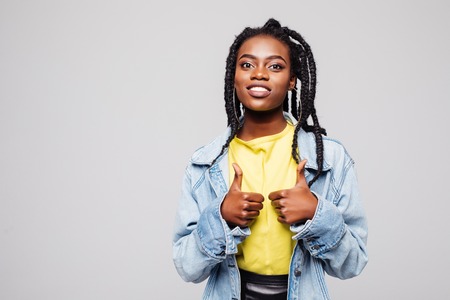 Happy Afro-American young woman isolated on white doing a thumbs-up signal with her handの写真素材