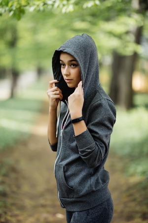 Young attractive woman doing exercises in a park, outdoor sports