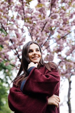 Girl with sakura tree flowers. Focus on face.の写真素材