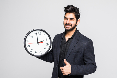 Portrait of a indian business man with clock isolated on whiteの写真素材