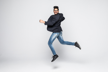 Excited Indian businessman jumping for joy. Isolated on white background.の写真素材
