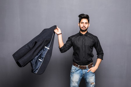 Indian man in business clothes which throws the jacket at camera isolated grayの写真素材