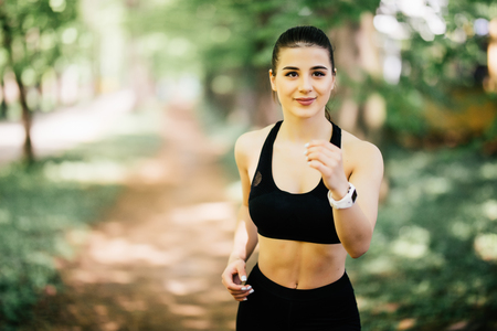 Running woman. Female Runner Jogging during Outdoor Workout in a Park.