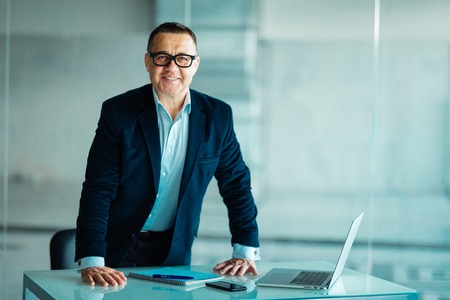 Senior businessman working on laptop computer in office