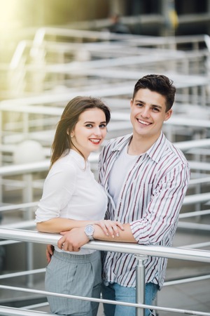 Romantic couple in love standing on stairs outdoors in the city street near buildingの写真素材