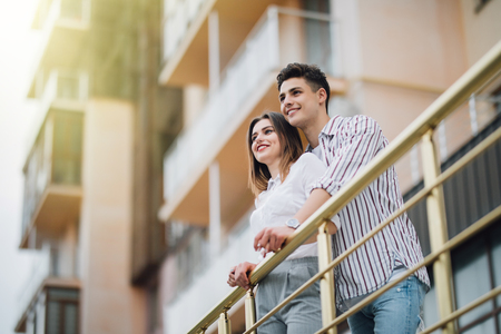 romantic happy couple relax and have fun at balcony in their new home apartmentの写真素材